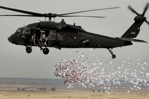 Soldiers from the U.S. Army's 350th Tactical Psychological Operations, 10th Mountain Division, drop leaflets over a village near Hawijah in Kirkuk province, Iraq, on March 6, 2008. The leaflets are intended to promote the idea of self-government to area residents.