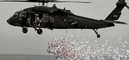 Soldiers from the U.S. Army's 350th Tactical Psychological Operations, 10th Mountain Division, drop leaflets over a village near Hawijah in Kirkuk province, Iraq, on March 6, 2008. The leaflets are intended to promote the idea of self-government to area residents.