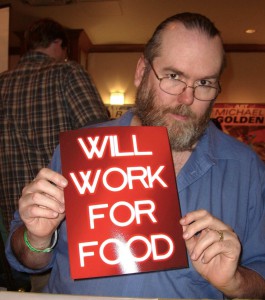 Comic book creator Moose Baumann at the Big Apple Convention in Manhattan, October 2, 2010. Baumann is holding up a "Will Work For Food" sign as a comment on his being fired from the Green Lantern job years previously. Photo by Luigi Novi.
